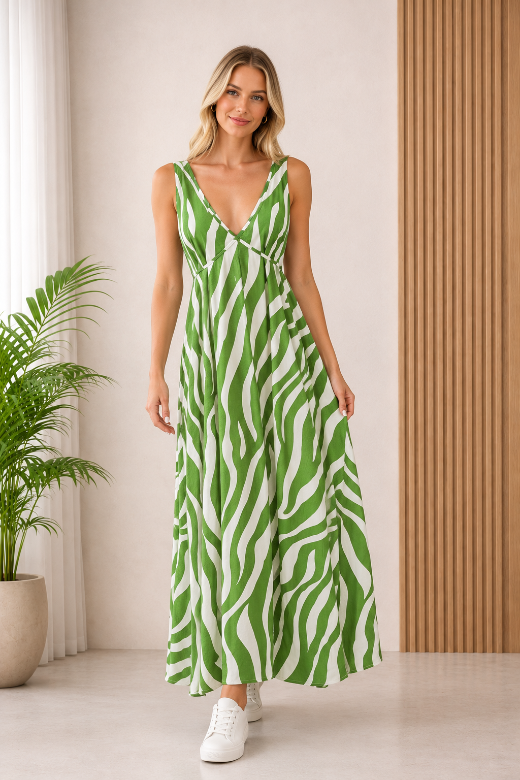 Model wearing Zade Emerald Green Zebra Print Maxi Dress with a deep V-neckline and flowy silhouette.
