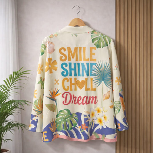 Women's tropical print statement blazer featuring colourful parrot artwork, botanical leaves, floral accents and inspirational Smile Shine Choose Dream slogan on cream background.
